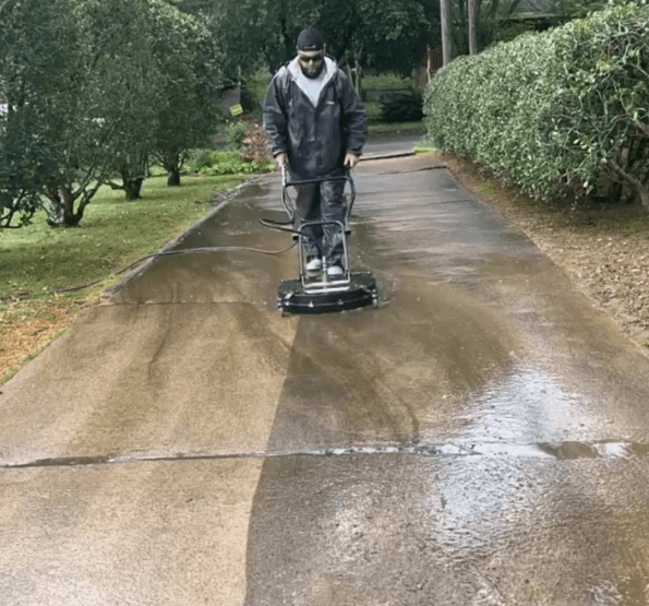 Pressure Washing concrete cleaning driveway with surface cleaner in Huntsville