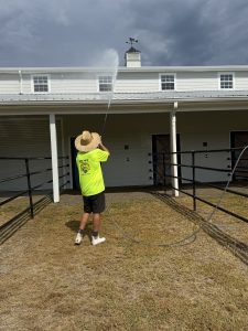 PSI OFF crew soft washing the barn gutterline and roofline at a private estate in New Hope AL