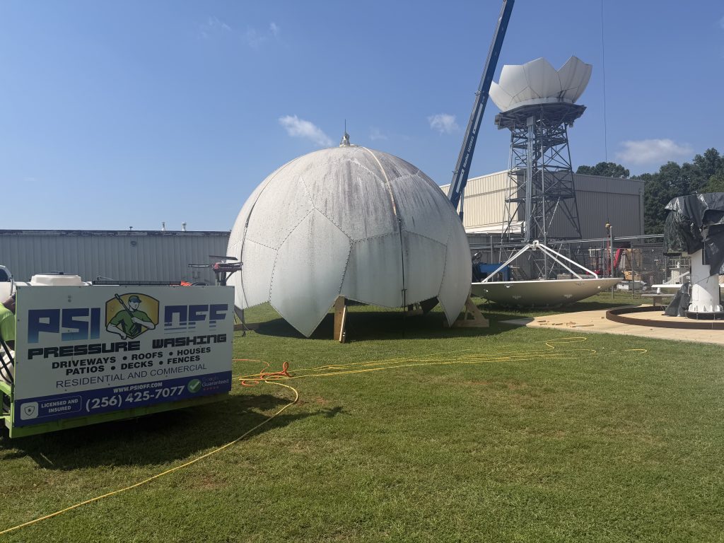 crane removing radome panel during dome cleaning huntsville al